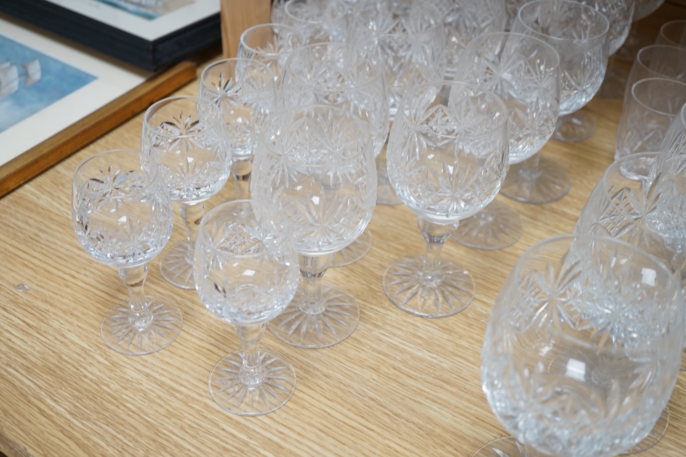 Various suites of star cut Thomas Webb drinking glasses, together with three decanters, pair of whisky tumblers and jug, five tumblers and three engraved Aston Villa champagne flutes, (approx. 89 items)
